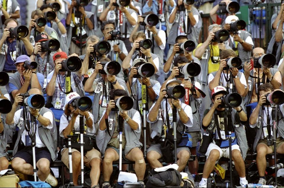 27 Jul 1996:  Photographers with their long lens pack the stands as they shoot during the 1996 Olympic Games at the Olympic Stadium in Atlanta, Georgia. Mandatory Credit: Gary M Prior  /Allsport
