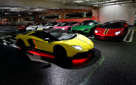 A Lamborghini Aventador goes past other supercars during a meeting of supercar fans at the Umihotaru parking area in Kisarazu, Japan October 21, 2017. Picture taken October 21, 2017. REUTERS/Toru Hanai