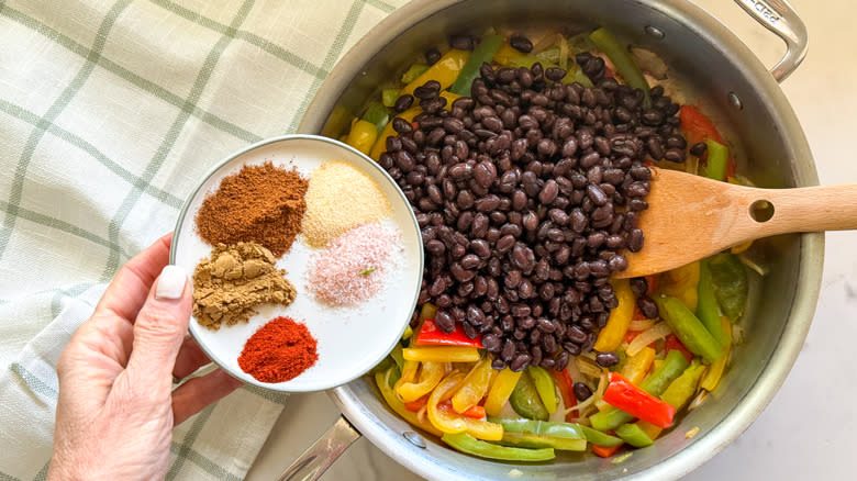 adding spices to pan