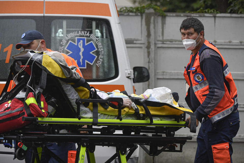 Paramedics bring an elderly patient to the emergency room, turned into a CODIV-19 unit due the high number of cases, at the Bagdasar-Arseni hospital in Bucharest, Romania, Tuesday, Oct. 12, 2021. Romania reported on Tuesday nearly 17,000 new COVID-19 infections and 442 deaths, the highest number of coronavirus infections and deaths in a day since the pandemic started, as the nation's health care system struggles to cope with an acute surge of new cases.(AP Photo/Andreea Alexandru)