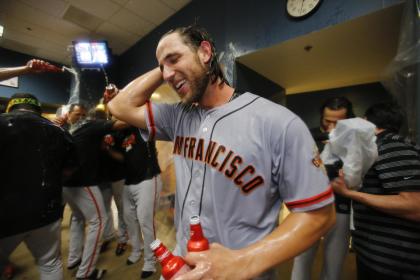 Madison Bumgarner enjoys the spoils of his dominant victory. (AP)