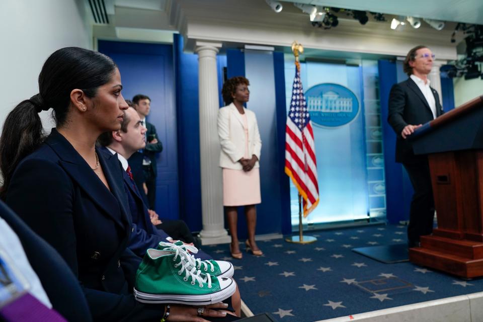 Camila Alves McConaughey holds the lime green Converse tennis shoes that were worn by Uvalde shooting victim Maite Yuleana Rodriguez, 10, as Matthew McConaughey, a native of Uvalde, Texas, joins White House press secretary Karine Jean-Pierre for the daily briefing at the White House in Washington, Tuesday, June 7, 2022.