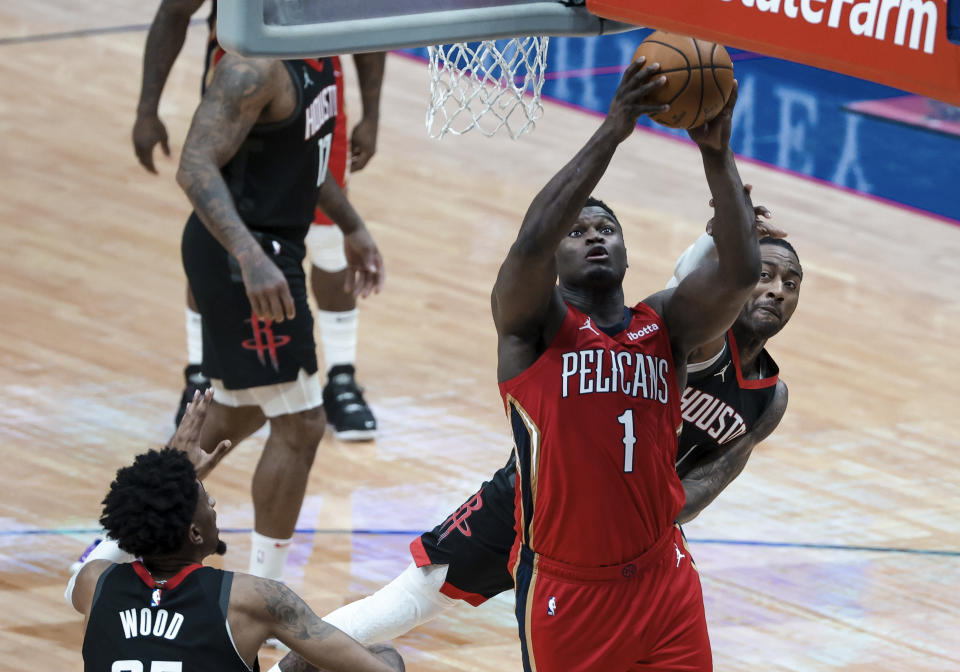 New Orleans Pelicans forward Zion Williamson (1) shoots over Houston Rockets guard John Wall (1) in the third quarter of an NBA basketball game in New Orleans, Saturday, Jan. 30, 2021. (AP Photo/Derick Hingle)