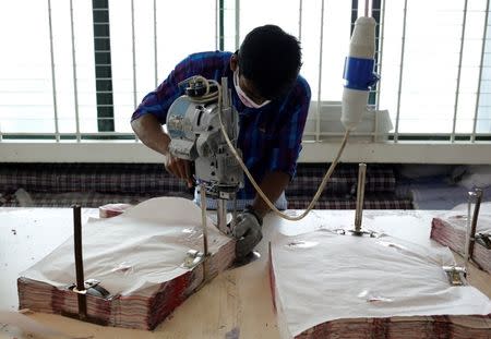 A woman works at a Babylon garment factory in Dhaka, Bangladesh July 13, 2016. Picture taken July 13, 2016.REUTERS/Mohammad Hossian Ponir