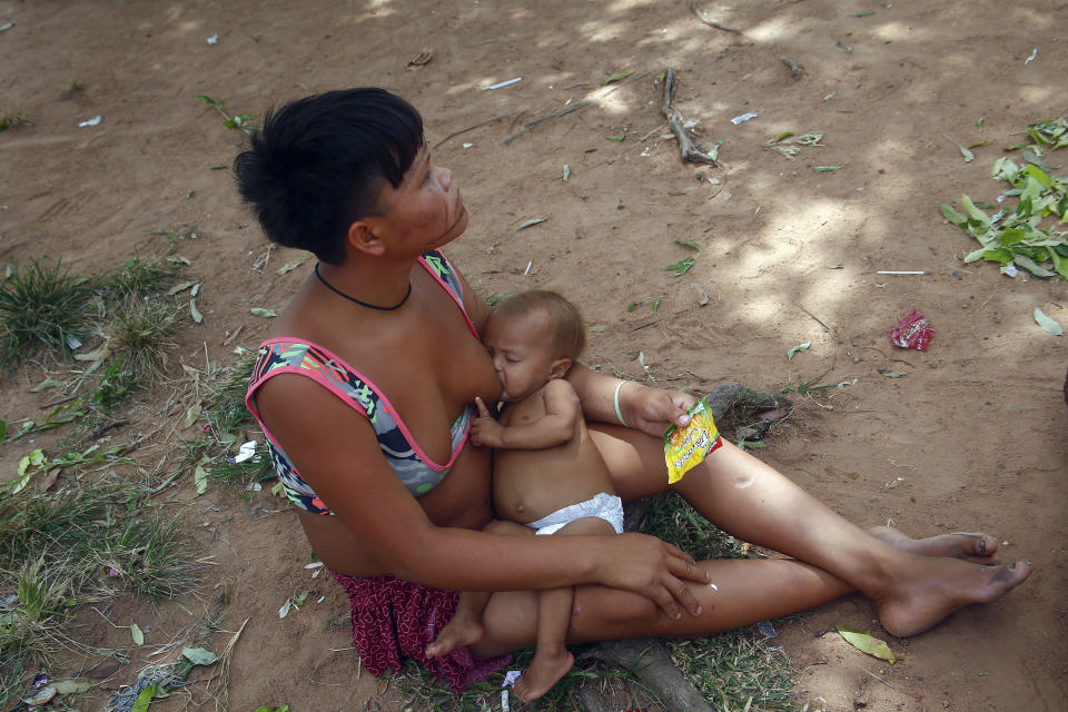 A Yanomami Indigenous breastfeeds her baby outside the Health Indigenous House, a center responsible for supporting and assisting Indigenous people, in Boa Vista, Roraima state, Brazil, Wednesday, Feb. 8, 2023. (AP Photo/Edmar Barros)