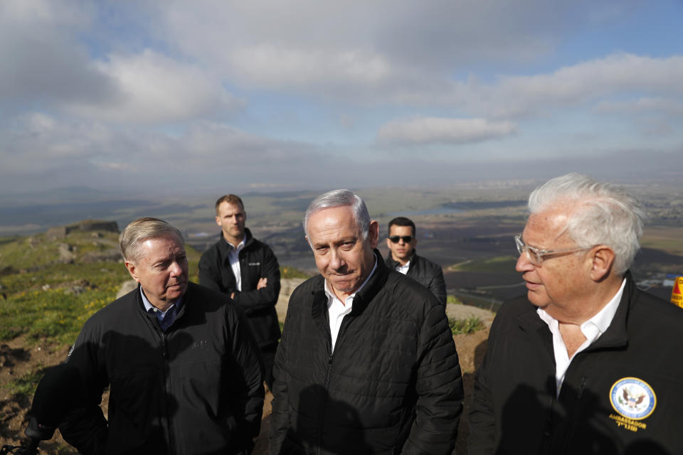 FILE - In this March 11, 2019, file photo, Israeli Prime Minister Benjamin Netanyahu, center, Republican U.S. Senator Lindsey Graham, left, and U.S. Ambassador to Israel David Friedman, right, visit the border between Israel and Syria in the Israeli-held Golan Heights. Graham says he will push for American recognition of Israeli sovereignty over the Golan Heights, a territory Israel captured from Syria in the 1967 Mideast War. (Ronen Zvulun/Pool Photo via AP, File)