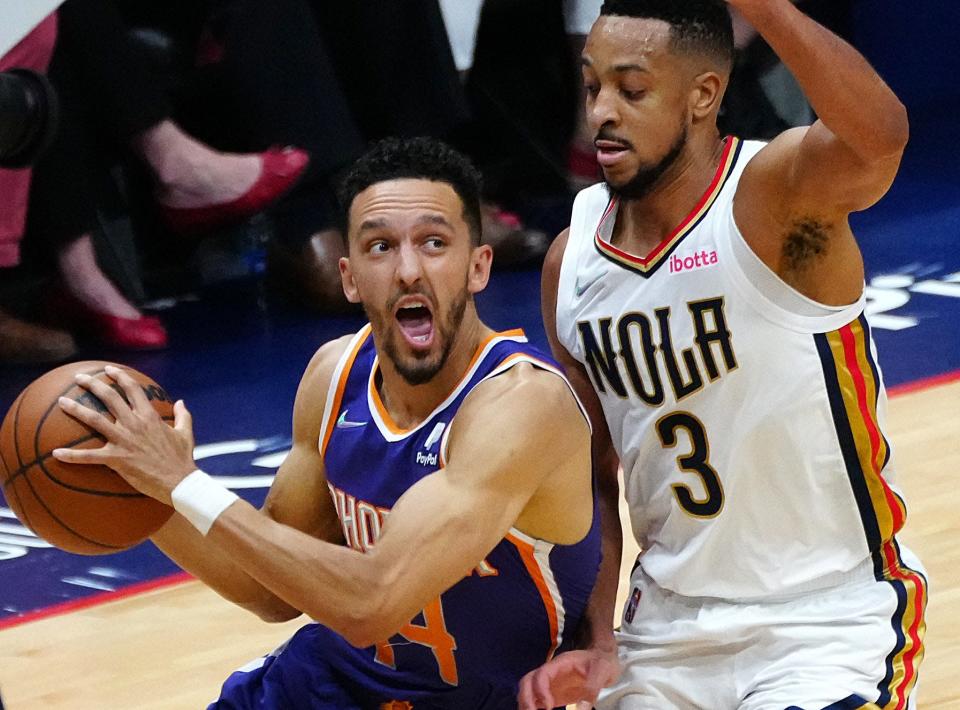 Suns' Landry Shamet (14) drives on Pelicans' CJ McCollum (3) during Game 6 of the first round of the Western Conference Playoffs.