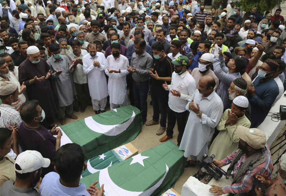 Mourners attend a funeral for some of the people who died in the crash of a state-run Pakistan International Airlines plane May 22, in Karachi, Pakistan, Tuesday, June 2, 2020. (AP Photo/Fareed Khan)