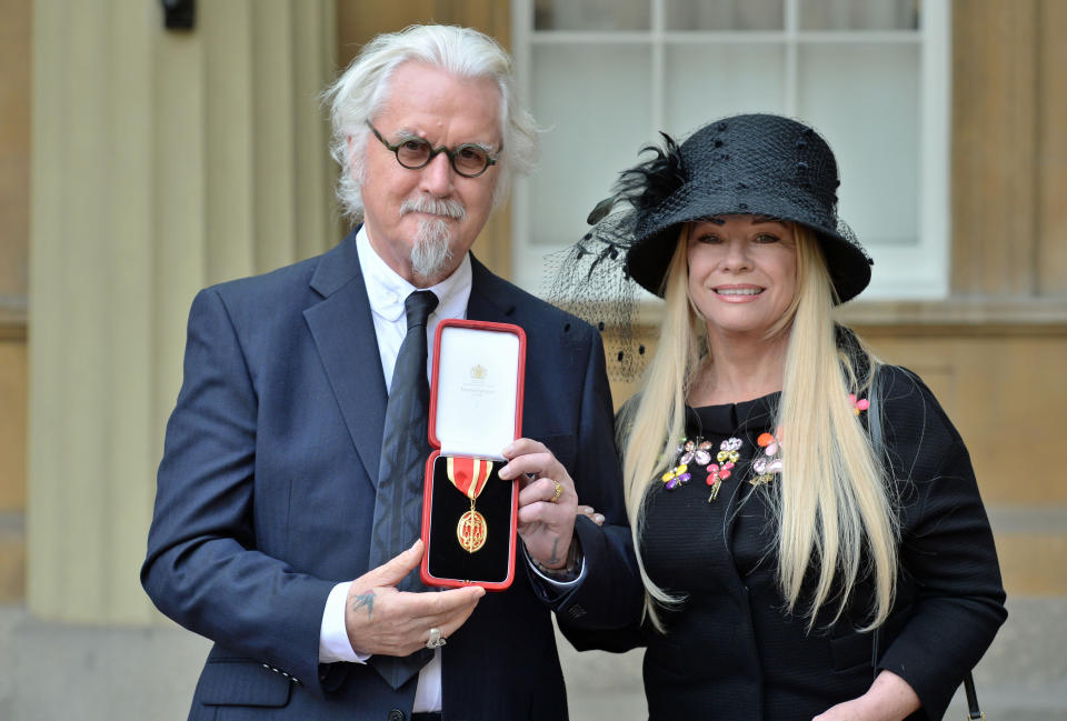 Sir Billy Connolly with his wife Pamela Stephenson after being knighted by the Duke of Cambridge during an Investiture ceremony at Buckingham Palace, London.
