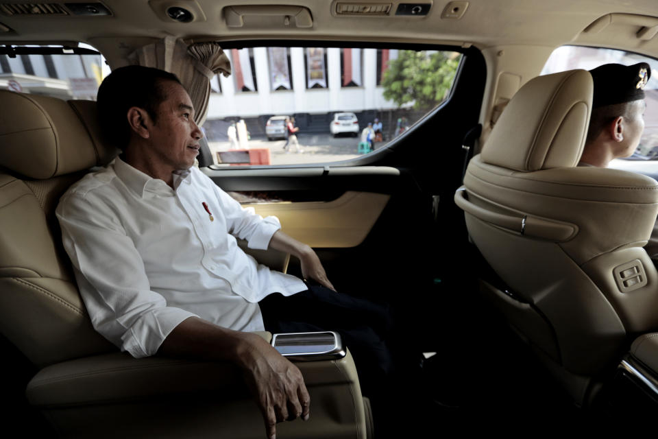 Indonesian President Joko Widodo sits in his car in Jakarta, Indonesia, Friday, July 26, 2019. Indonesian President Joko Widodo said in an interview Friday that he will push ahead with sweeping and potentially unpopular economic reforms, including a more business-friendly labor law, in his final term because he is no longer constrained by politics. (AP Photo/Dita Alangkara)