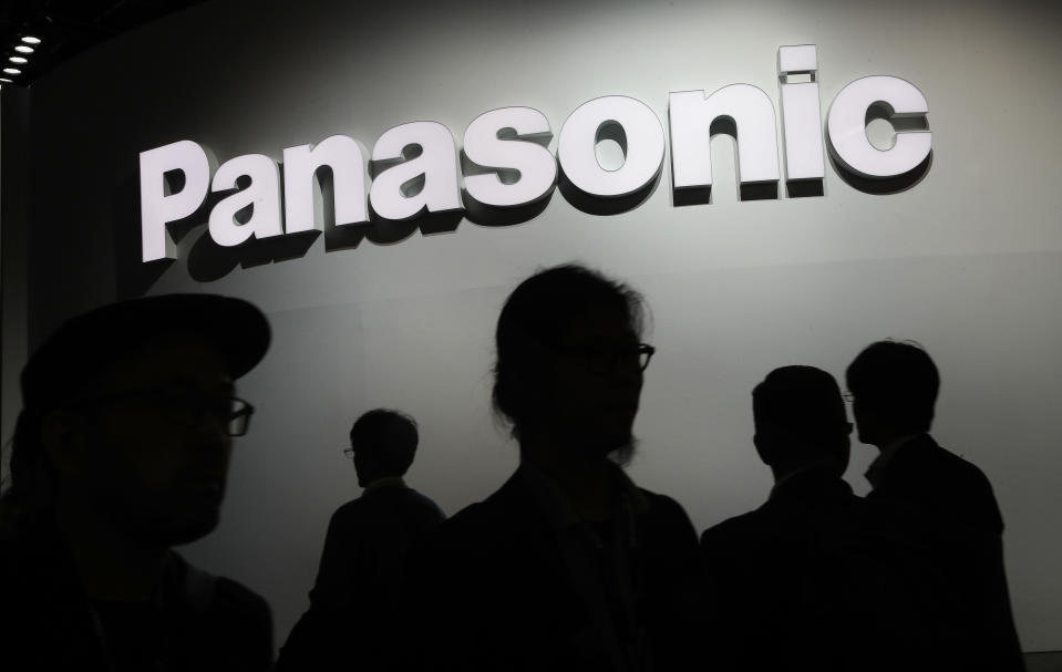 FILE - People walk by the Panasonic booth during CES International, on Jan. 9, 2018, in Las Vegas. Japan’s Panasonic Corp. selected Kansas as the location for a multibillion-dollar mega-factory to produce electric vehicle batteries for Tesla and other carmakers, Gov. Laura Kelly announced Wednesday, July 13, 2022. (AP Photo/John Locher, File)