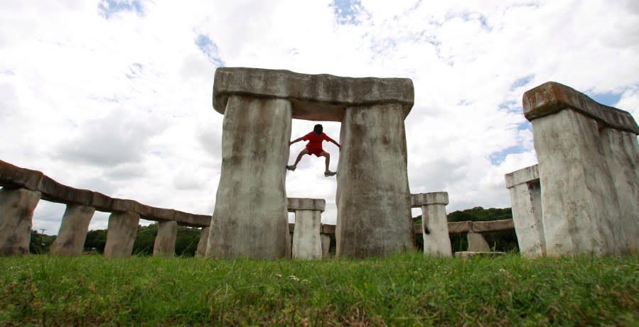 Wilson Farris climbs a structure at Stonehenge II, Thursday, July 22, 2010, in Hunt, Texas. The Stonehenge replica, built by Doug Hill and Al Shepperd in 1989, was moved to a new home in Ingram shortly after the photo was taken. (AP Photo/Eric Gay)