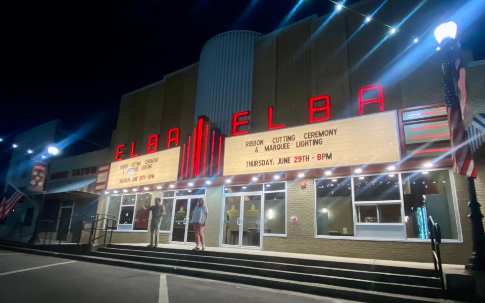 Justin Maddox, left, and Laurie Chapman welcome a crowd as the lights go on at Elba Theatre on June 29, 2023, in Elba, Alabama.