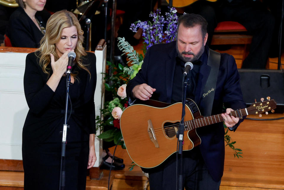 Trisha Yearwood and Garth Brooks performing at the tribute service for former first lady Rosalynn Carter. / Credit: EVELYN HOCKSTEIN / REUTERS
