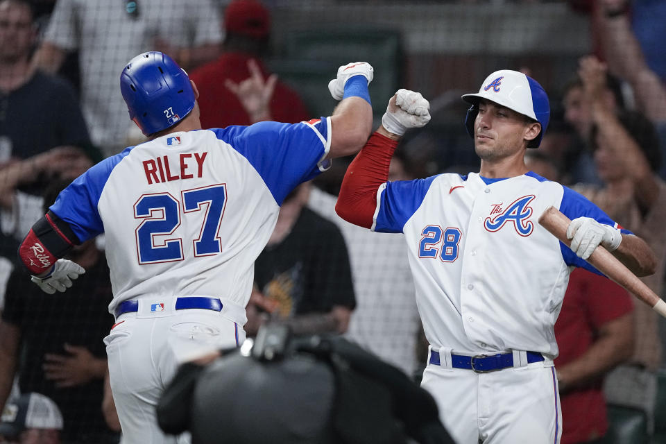 Atlanta Braves' Austin Riley (27) celebrates with Matt Olson (28) after hitting a solo home run in the seventh inning of a baseball game against the Milwaukee Brewers, Friday, July 28, 2023, in Atlanta. Olson hit a home run in his at-bat. (AP Photo/John Bazemore)