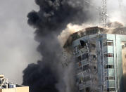 The building housing the offices of The Associated Press and other media in Gaza City collapses after it was hit by an Israeli airstrike Saturday, May 15, 2021. The attack came roughly an hour after the Israeli military warned people to evacuate the building, which also housed Al-Jazeera and a number of offices and apartments. There was no immediate explanation for why the building was targeted. (AP Photo/Hatem Moussa)