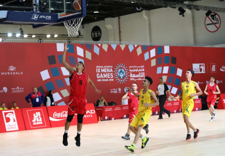 Athletes compete in a basketball match during the 9th Middle East and North Africa Special Olympics in Abu Dhabi on March 19, 2018