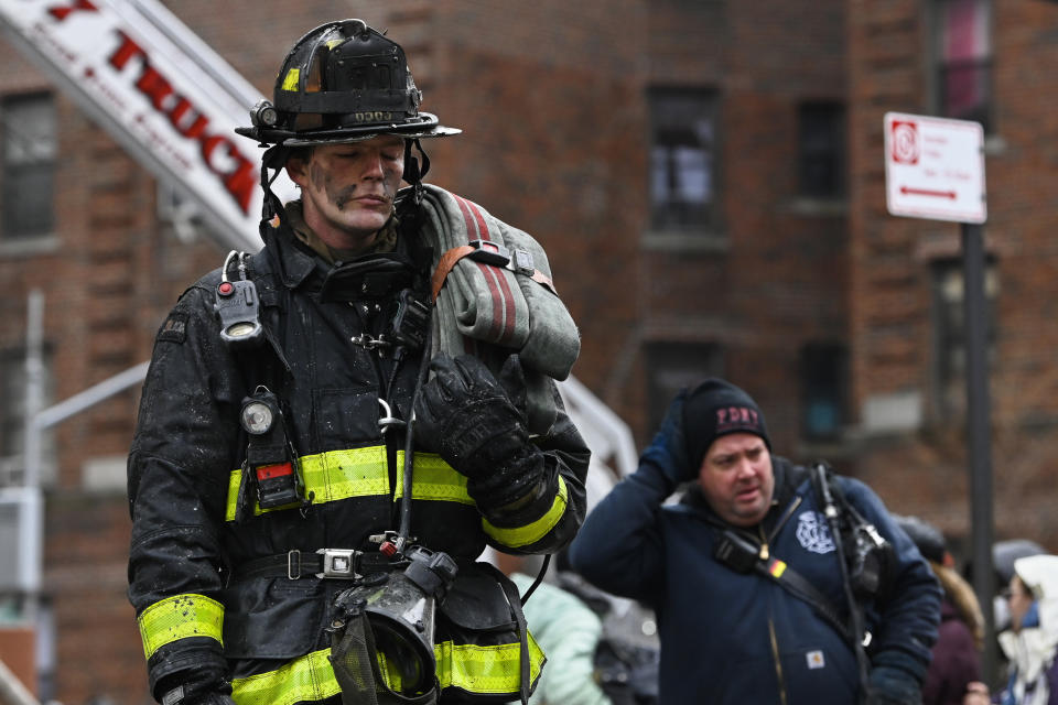 Emergency personnel respond to a high rise fire at 333 East 181 Street, Sunday, Jan. 9, 2022, in the Bronx borough of New York. (AP Photo/Lloyd Mitchell)