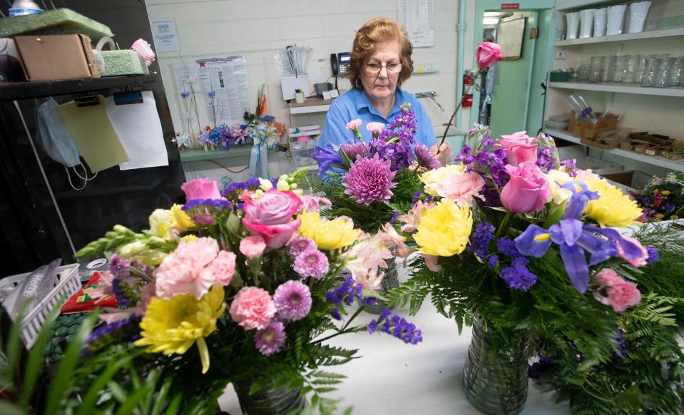 Jean Huff, a longtime employee of Grandview Florist, works on a Mother's Day flower arraignment on Wednesday.