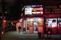 A man walks past an open Kennedy Fried Chicken restaurant in the Queens borough of New York, Thursday night, April 23, 2020, during the coronavirus pandemic. The New York City immortalized in song and scene has been swapped out for the last few months with the virus version. In all the unknowing of what the future holds, there's faith in that other quintessential facet of New York City: that the city will adapt. (AP Photo/Mark Lennihan)