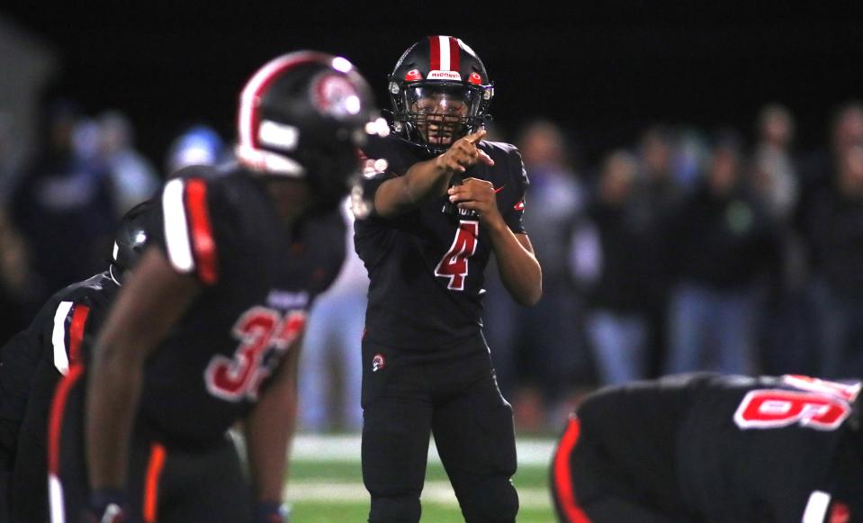 Aliquippa quarterback Quentin Goode (4) calls out to his team during the first half against Centra Valley Friday night at Jimbo Covert Field in Freedom, PA.