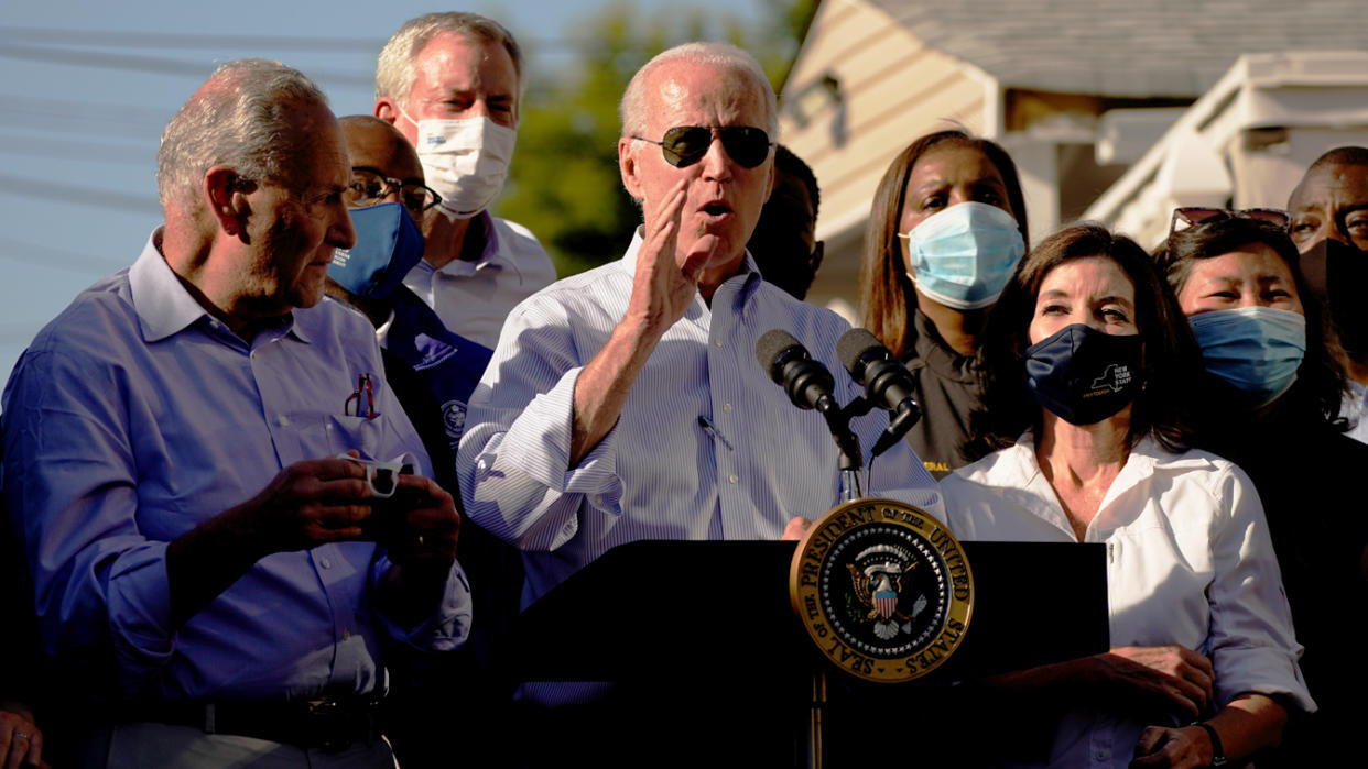 President Biden speaks as Gov. Kathy Hochul of New York, right, and Senate Majority Leader Chuck Schumer, left, look on in Queens, N.Y., on Tuesday. 