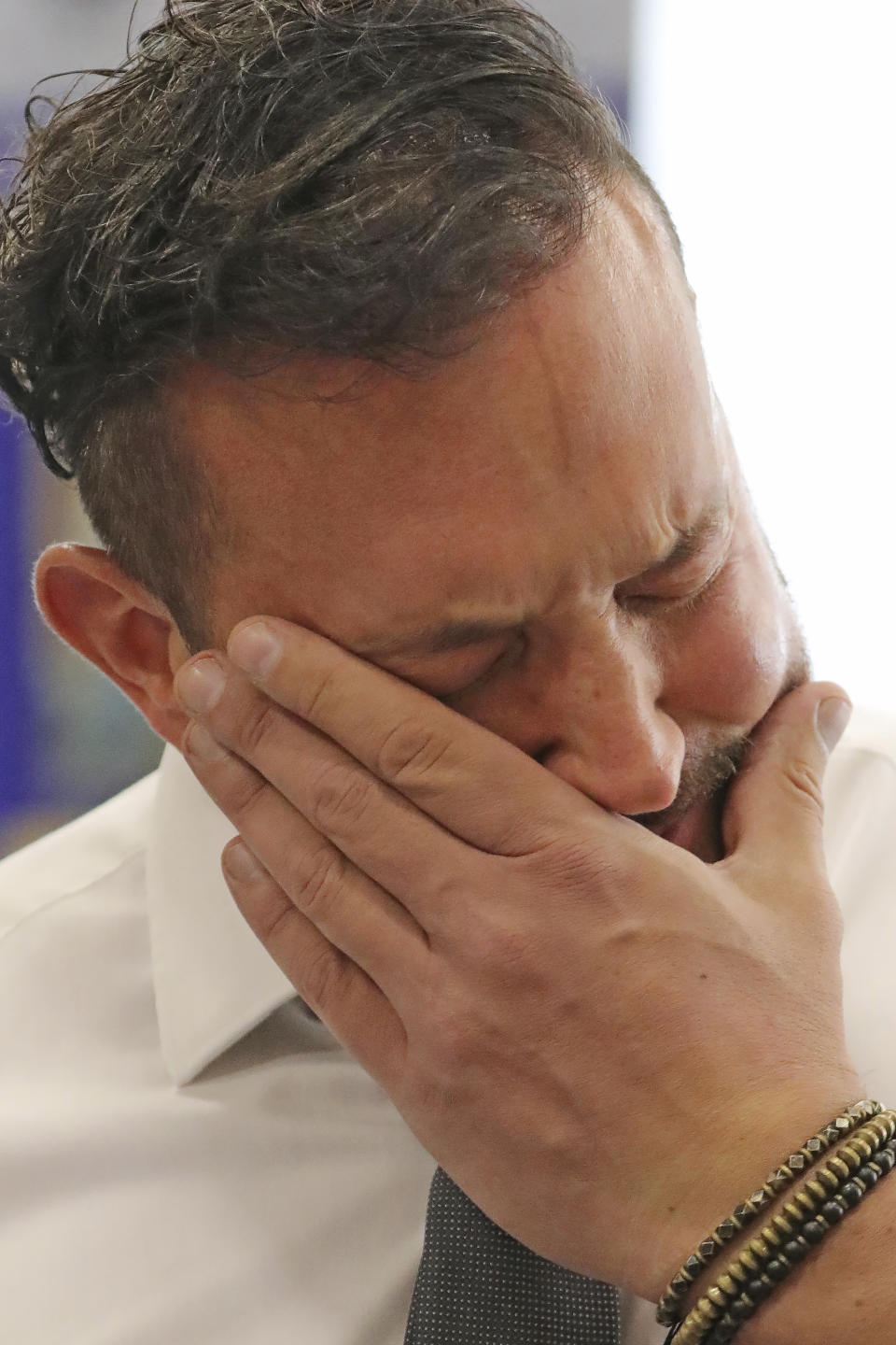 FILE - In this Sept. 26, 2019, file photo, Justin Utley fights back his emotions as he remembers conversion therapy following a hearing in Salt Lake City. The Church of Jesus of Christ of Latter-day Saints is opposing a proposed ban on conversion therapy in Utah, just months after it said it wouldn't stand in the way of a similar rule under consideration. The church said in a statement posted Tuesday, Oct. 15, 2019, night that the regulatory rule prohibiting Utah psychologists from engaging in LBGTQ conversion therapy with minors would fail to safeguard "religious beliefs" and doesn't account for "important realities of gender identity in the development of children." (AP Photo/Rick Bowmer, File)