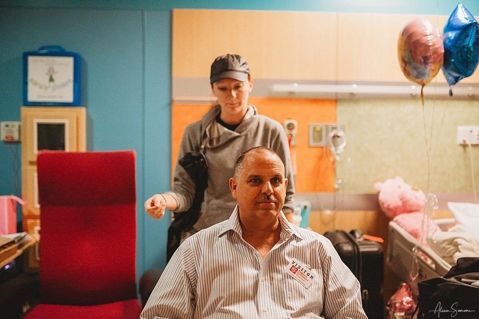 Madi's grandfather sits down to cut his hair to show support for his granddaughter. (Photo: Alicia Samone Photography)