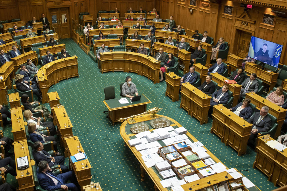 Ukrainian President Volodymyr Zelenskyy appears via video during his address to the New Zealand Parliament in Wellington Wednesday, Dec. 14, 2022. Zelenskyy urges New Zealand to take a leading role in focusing on the environmental destruction his country is suffering as a result of Russia's invasion. (Mark Mitchell/New Zealand Herald via AP)