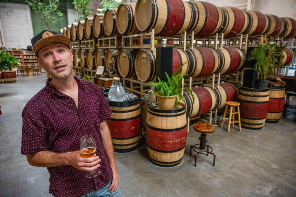 Owner Kevin Luther stands on Wednesday, July 12, 2023, in the 4,000 square-foot Lucid Winery space in midtown Sacramento. The winery features an herb-infused wine menu and invites the customers to enjoy its 8,000 book collection. It is has live music on Wednesdays.