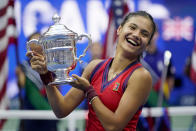 Emma Raducanu, of Britain, holds up the US Open championship trophy after defeating Leylah Fernandez, of Canada, during the women's singles final of the US Open tennis championships, Saturday, Sept. 11, 2021, in New York. (AP Photo/Seth Wenig)