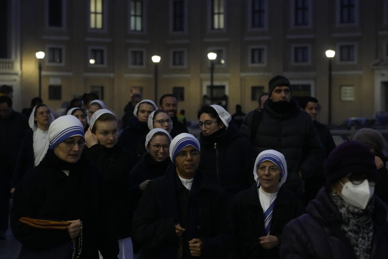 CORRECTS DATE TO JAN. 4 - Nuns arrive at dawn to view the body of Pope Emeritus Benedict XVI as it lies in state in St. Peter's Basilica at the Vatican, Wednesday, Jan. 4, 2023. The Vatican announced that Pope Benedict died on Dec. 31, 2022, aged 95, and that his funeral will be held on Thursday, Jan. 5, 2023. (AP Photo/Gregorio Borgia)