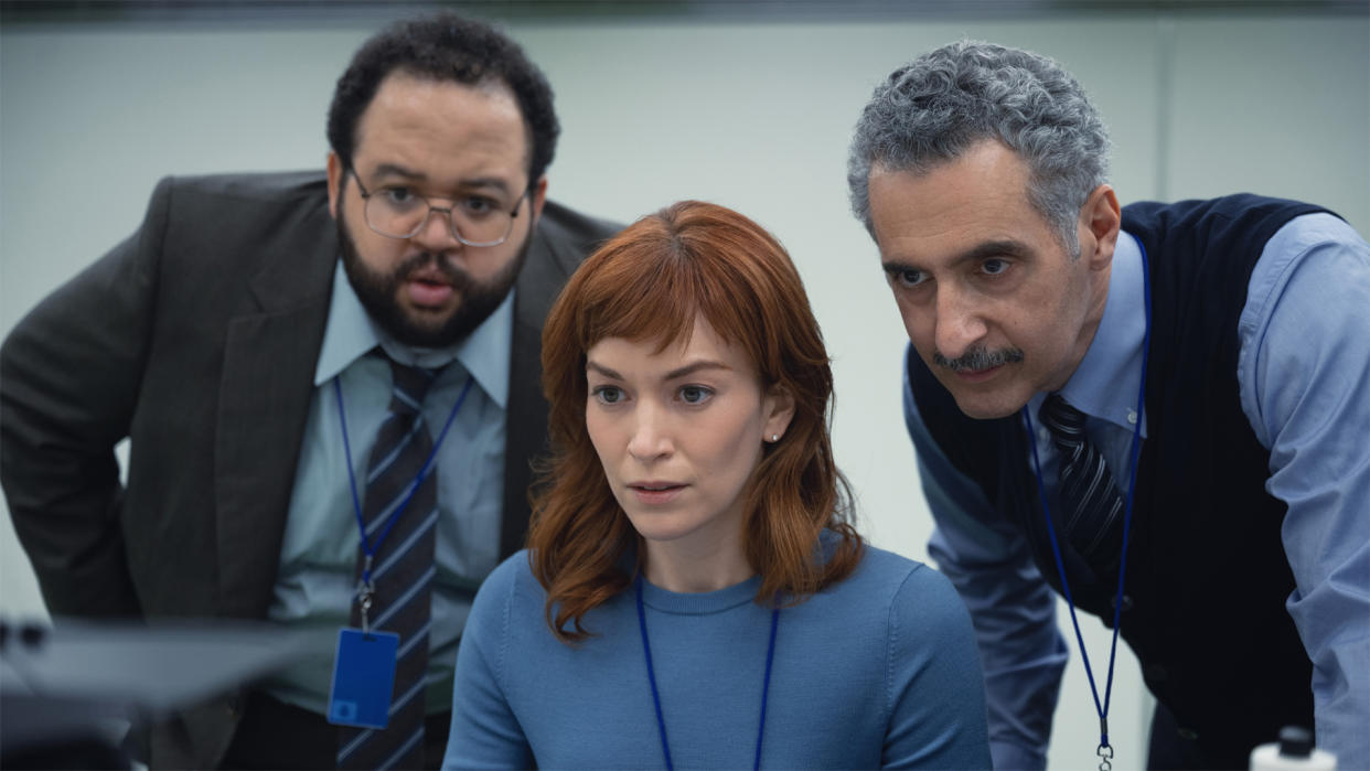  Severance image, showing three characters looking pensively at something off-camera 