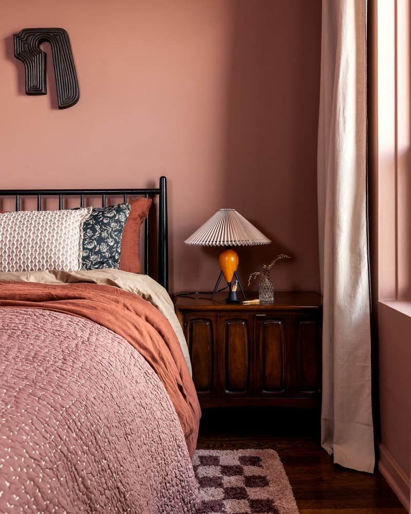 Lamp on bedside table in newly remodeled bedroom.