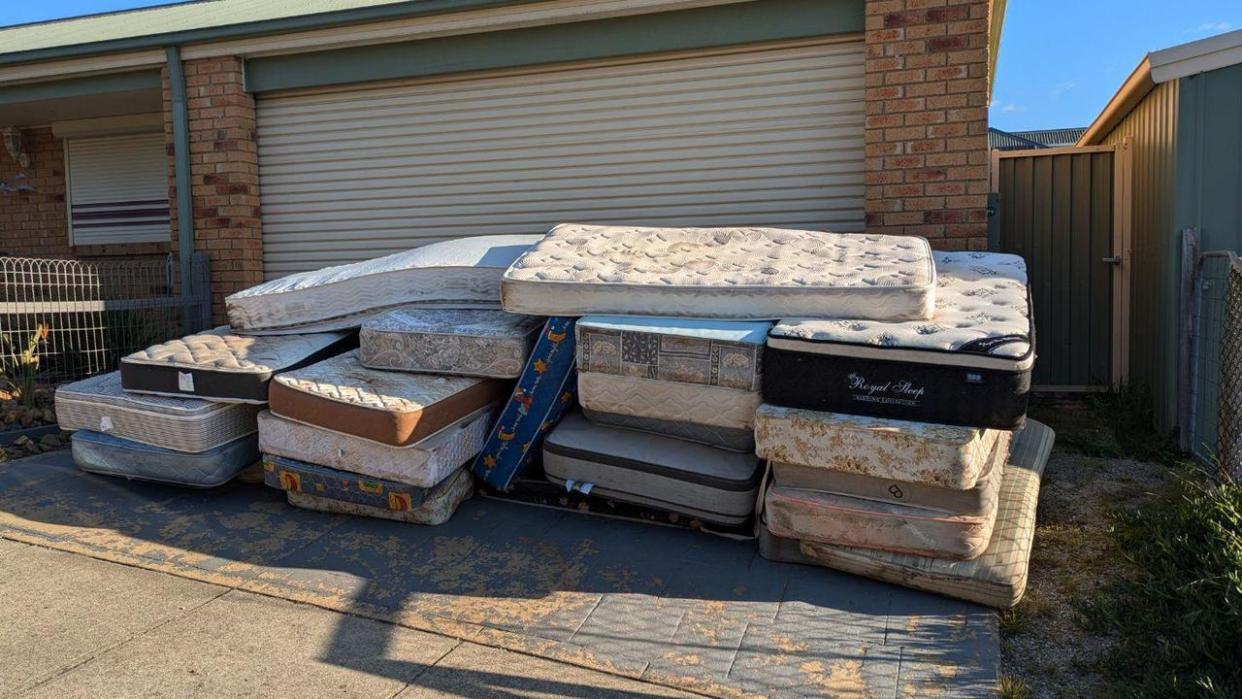 An invoice dispute has ended in legal action after a customer decided the fee was too high and the business dumped 26 old mattresses on the customer's driveway for an unpaid bill. Picture: Reddit