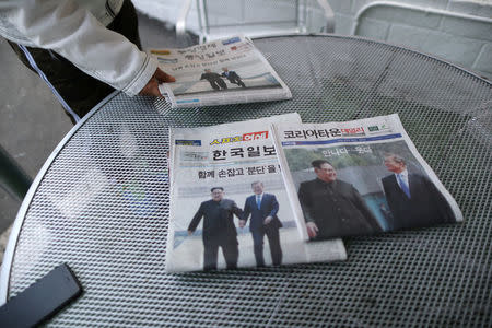 Newspapers with front page stories about the inter-Korean summit between North Korea’s Kim Jong Un and South Korean President Moon Jae-in are seen in Koreatown, Los Angeles, California, April 27, 2018. REUTERS/Lucy Nicholson