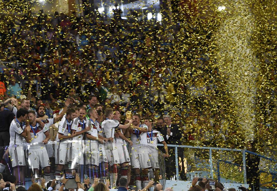 Germany's soccer players celebrate with the World Cup trophy after the 2014 World Cup final at the Maracana stadium in Rio de Janeiro