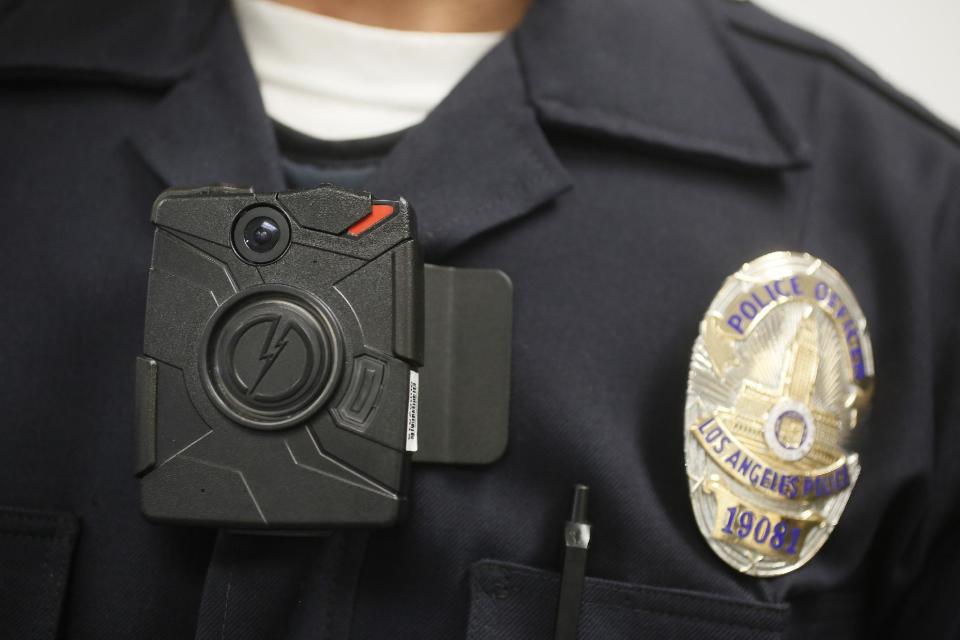 This Jan. 15, 2014 file photo shows a Los Angeles Police officer wearing an on-body cameras during a demonstration for media in Los Angeles. Thousands of police agencies have equipped officers with cameras to wear with their uniforms, but they’ve frequently lagged in setting policies on how they’re used, potentially putting privacy at risk and increasing their liability. As officers in one of every six departments across the nation now patrols with tiny lenses on their chests, lapels or sunglasses, administrators and civil liberties experts are trying to envision and address troublesome scenarios that could unfold in front of a live camera. (AP Photo/Damian Dovarganes)