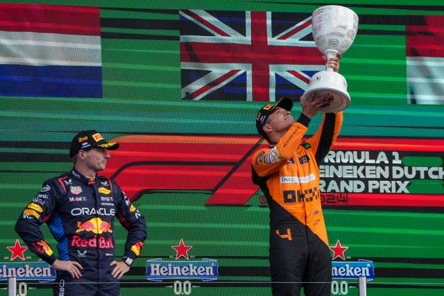 Lando Norris holding up his trophy