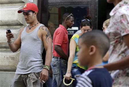 A man uses his mobile phone on a street in Havana April 6, 2014. REUTERS/Enrique De La Osa