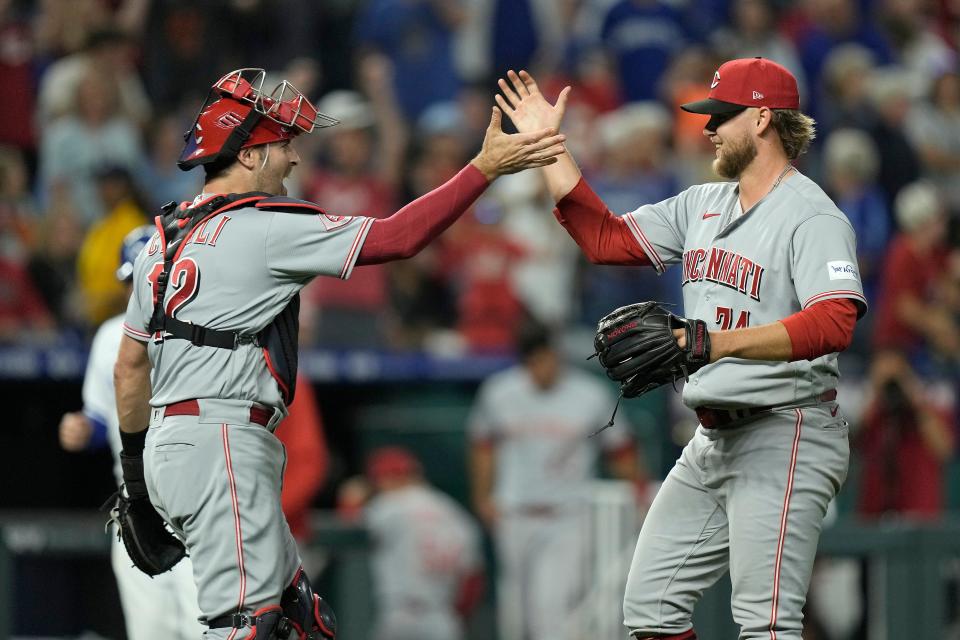 Cincinnati Reds relief pitcher Ricky Karcher and catcher Curt Casali celebrate after Monday night's 5-4 win against the Royals. Karcher, who pitched at Ponte Vedra High School, earned the save in his MLB debut.