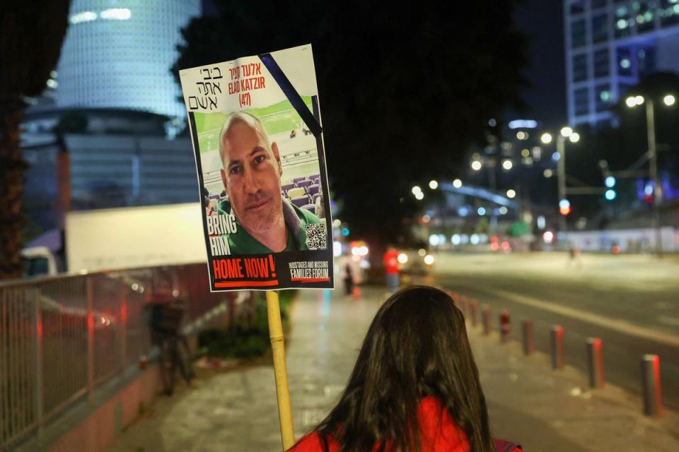 A woman holds a placard bearing the portrait of 47-year-old Israeli hostage Elad Katzir (AFP via Getty Images)