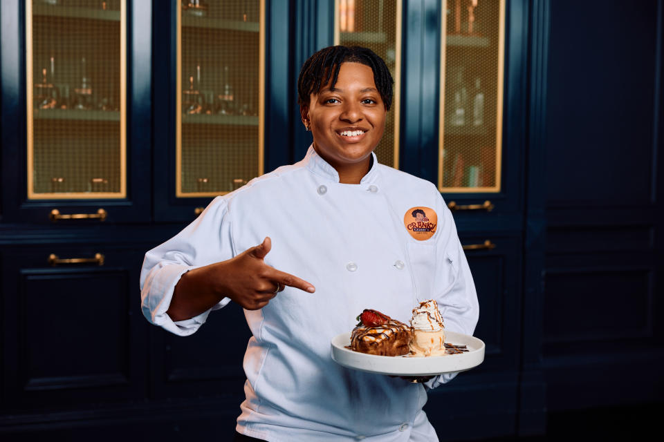 Sianni Dean, owner of Cranky Granny's, holding their Churro Cinnamon Roll