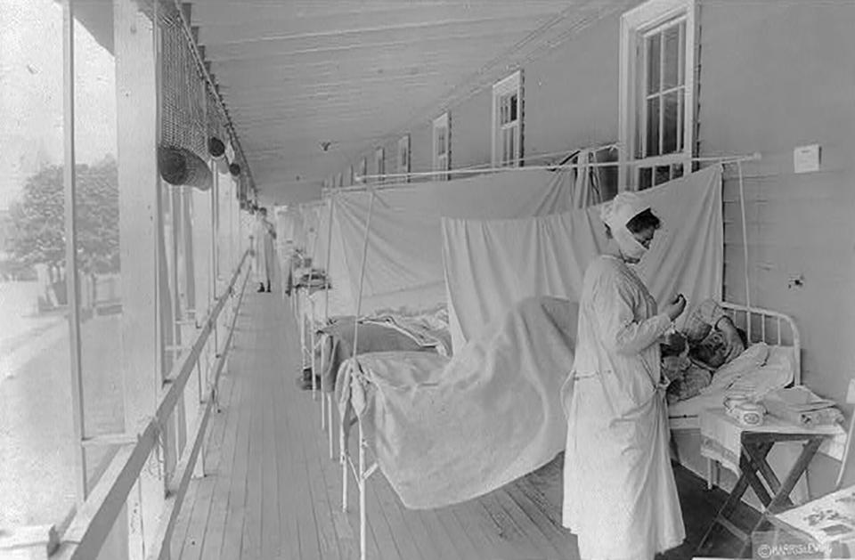 A nurse takes the pulse of a patientin the influenza ward at Walter Reed Hospital during the Spanish Flu pandemic in Washington, U.S. November 1, 1918.  Library of Congress/Harris & Ewing/Handout via REUTERS THIS IMAGE HAS BEEN SUPPLIED BY A THIRD PARTY.