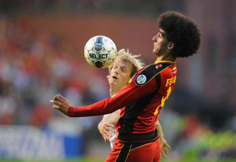 Belgium's midfielder Marouane Fellaini (R) vies for the ball during the 2014 World Cup Qualifying football match against Serbia in Brussels on June 7, 2013