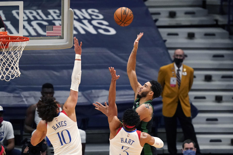 Boston Celtics forward Jayson Tatum shoots against New Orleans Pelicans center Jaxson Hayes (10) and guard Josh Hart (3) in the first half of an NBA basketball game in New Orleans, Sunday, Feb. 21, 2021. (AP Photo/Gerald Herbert)