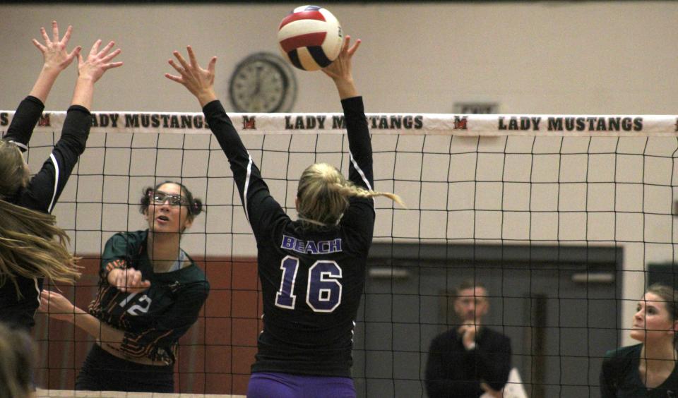 Mandarin's Paola Aviles Morales (12) spikes the ball against Fletcher in the 2022 Gateway Conference volleyball tournament.