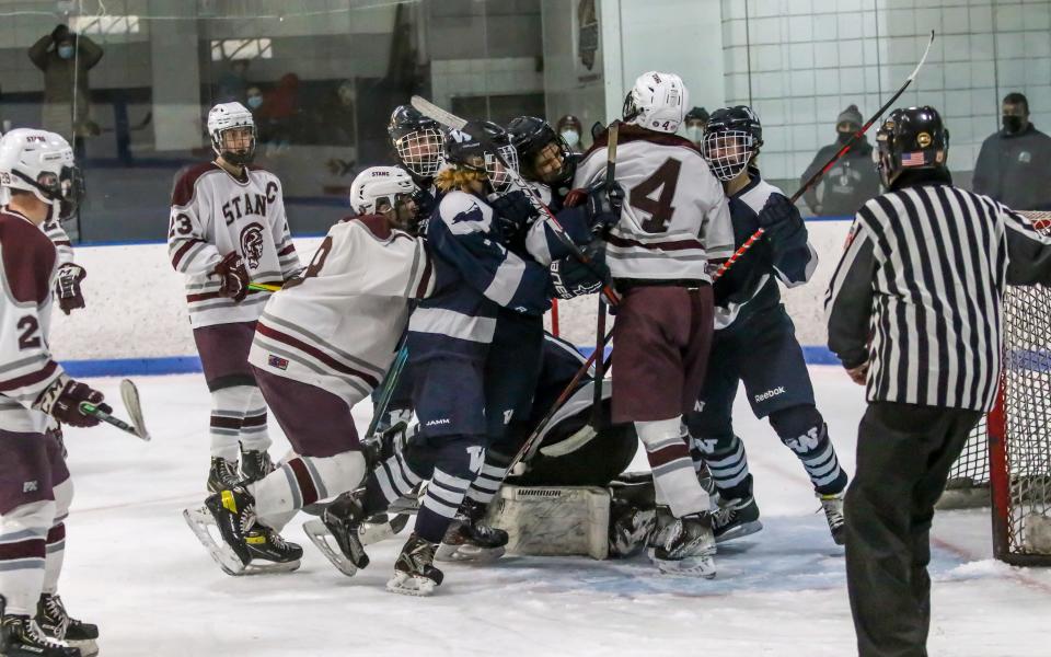 Bishop Stang's Jack Jedrey is met by three Nantucket players as Jedrey attempted to get a rebound in the Nantucket goal crease.