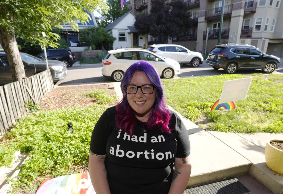 Leah Dean, a native of the Texas Panhandle, poses outside her home Monday, July 3, 2023, in Denver. Americans are segregating by their politics at a rapid clip, helping fuel the greatest divide between the states in modern history. (AP Photo/David Zalubowski)