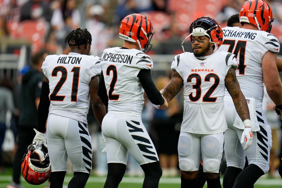Cincinnati Bengals running back Trayveon Williams (32) shakes hands with place kicker <a class="link " href="https://sports.yahoo.com/nfl/players/33537" data-i13n="sec:content-canvas;subsec:anchor_text;elm:context_link" data-ylk="slk:Evan McPherson;sec:content-canvas;subsec:anchor_text;elm:context_link;itc:0">Evan McPherson</a> (2) as they wrap up warmups before the first quarter of the NFL Week 1 game between the <a class="link " href="https://sports.yahoo.com/nfl/teams/cleveland/" data-i13n="sec:content-canvas;subsec:anchor_text;elm:context_link" data-ylk="slk:Cleveland Browns;sec:content-canvas;subsec:anchor_text;elm:context_link;itc:0">Cleveland Browns</a> and the Cincinnati Bengals at FirstEnergy Stadium in downtown Cleveland on Sunday, Sept. 10, 2023.